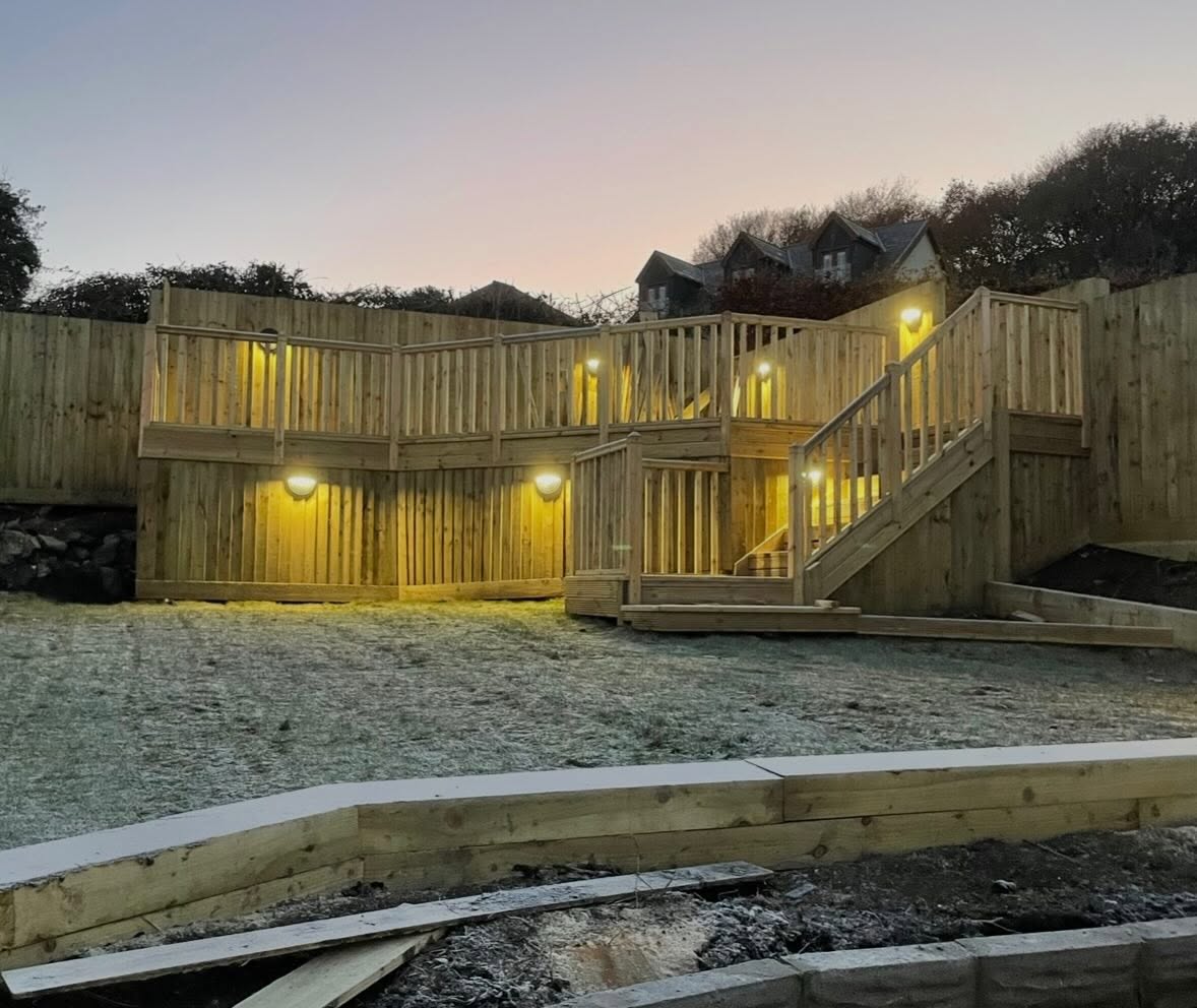 Two tier timber deck lit at dusk