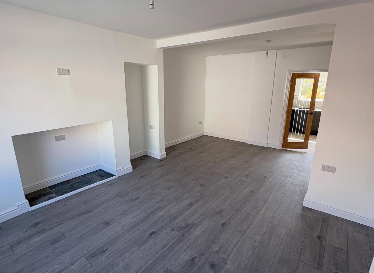 Fully renovated living room with wood floor